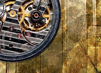 Watch mechanism close-up on the old grungy gold background
