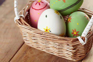 Eggs in basket on wood a