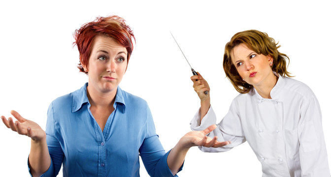 young female chef and waitress co-workers fighting