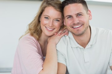 Couple smiling in kitchen