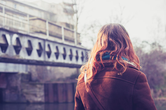 Young woman looking at rail brdge