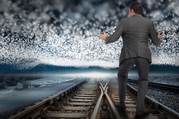 Composite image of businessman standing with arms out