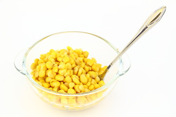 The corn in glass dish on the white background
