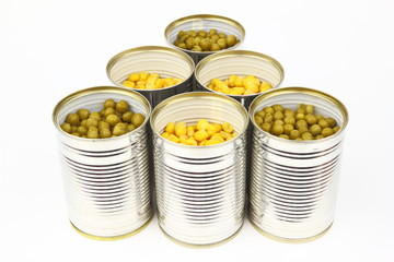 The tins with peas, corn on the white background