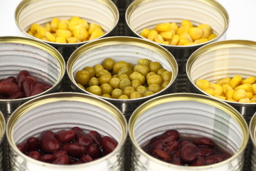 The tins with peas, red bean, corn on the white background