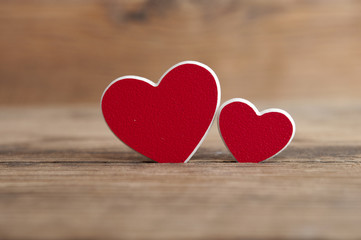 two red hearts on wooden background