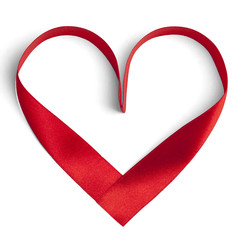 Red ribbon in a heart shape isolated on white