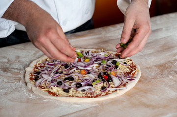 Chef preparing pizza, closeup shot