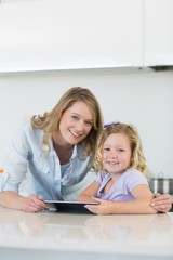 Mother and daughter with digital tablet