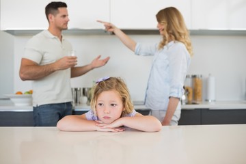 Obraz na płótnie Canvas Sad girl against arguing parents