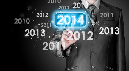 Businessman touching new year 2014