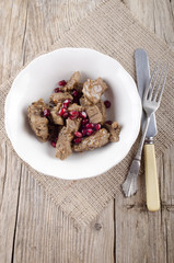 beef goulash and pomegranate seed in a bowl