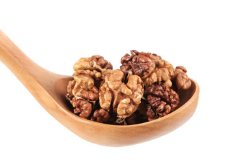 Wooden spoon full with walnuts.