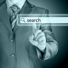 Businessman pushing virtual search bar