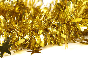 Close up of christmas yellow tinsel with stars.