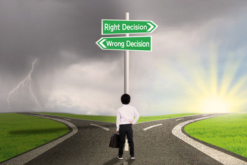 Business child with a sign of right vs wrong decision