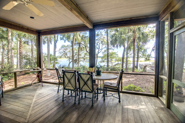 rustic porch with forest and waterfront view - obrazy, fototapety, plakaty