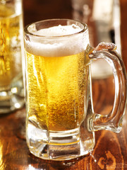 large mug of beer on wood counter