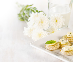 Several canapes and glass of milk