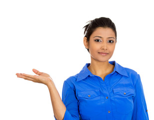 Smiling woman gesturing to copy space at left on white 