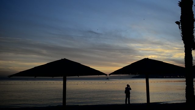 Silhouettes on the golden beach of the Red Sea, Eilat