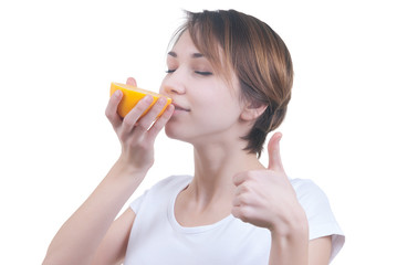 Girl sniffing half of grapefruit - 60587185