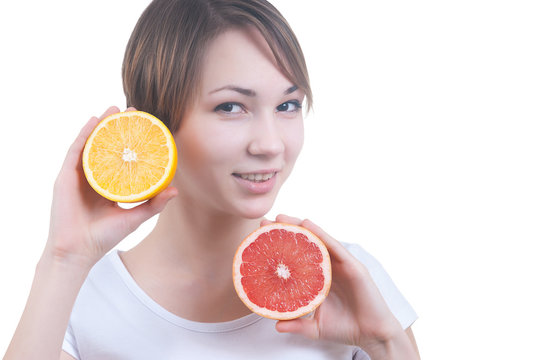 Girl holding the half of lemon and grapefruit