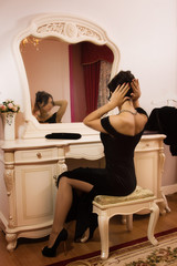 Elegant brunette in a luxurious interior.