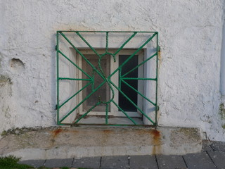 window with grid in sardinia, italy
