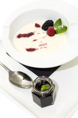 semolina porridge with berries decorated with berry jam