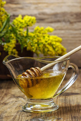 Bowl of honey on wooden background