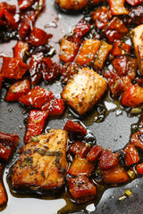Grilled salmon in herbs on frying pan
