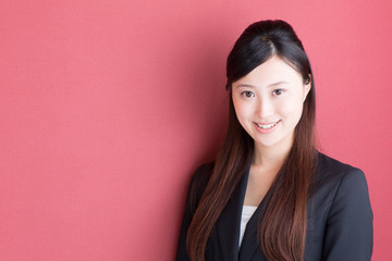 young asian businesswoman on red background