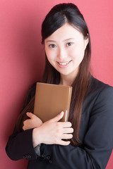 young asian businesswoman on red background