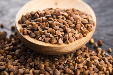 Buckwheat seeds on wooden spoon in closeup