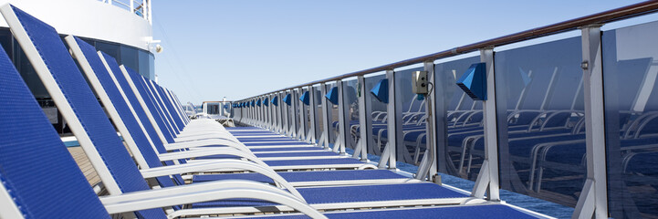 Lounge chairs on deck of luxury cruise ship