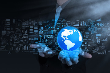 businessman hand the world and business strategy as concept