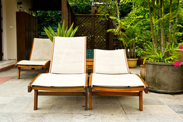 Long chairs by the pool
