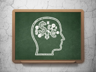 Marketing concept: Head With Finance Symbol on chalkboard