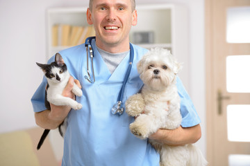 Happy vet with dog and cat