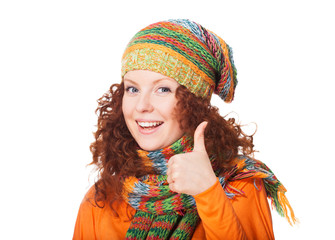 Smiling woman in winter outerwear giving thumb up