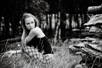 The resting young girl in the woods. Long hair dispelled by wind