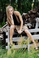 The resting young girl in the woods. Long hair dispelled by wind