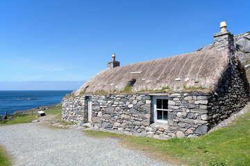 Traditional scottish black house on the edge of Atlantic Ocean