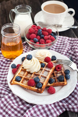 Belgian waffles with whipped cream and fresh berries