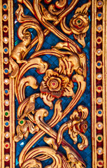 Ancient golden carving wooden window of Thai temple. Thailand