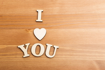 Wooden letters forming with phrase I Love You and over the woode