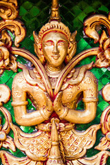 Naklejka premium Ancient golden carving wooden window of Thai temple. Thailand