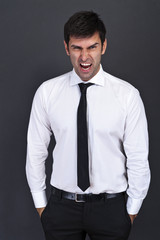angry businessman over dark background