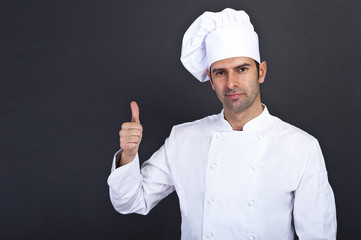 Male chef with thumb up portrait against grey background